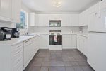 Bright white kitchen with plenty of amenities 